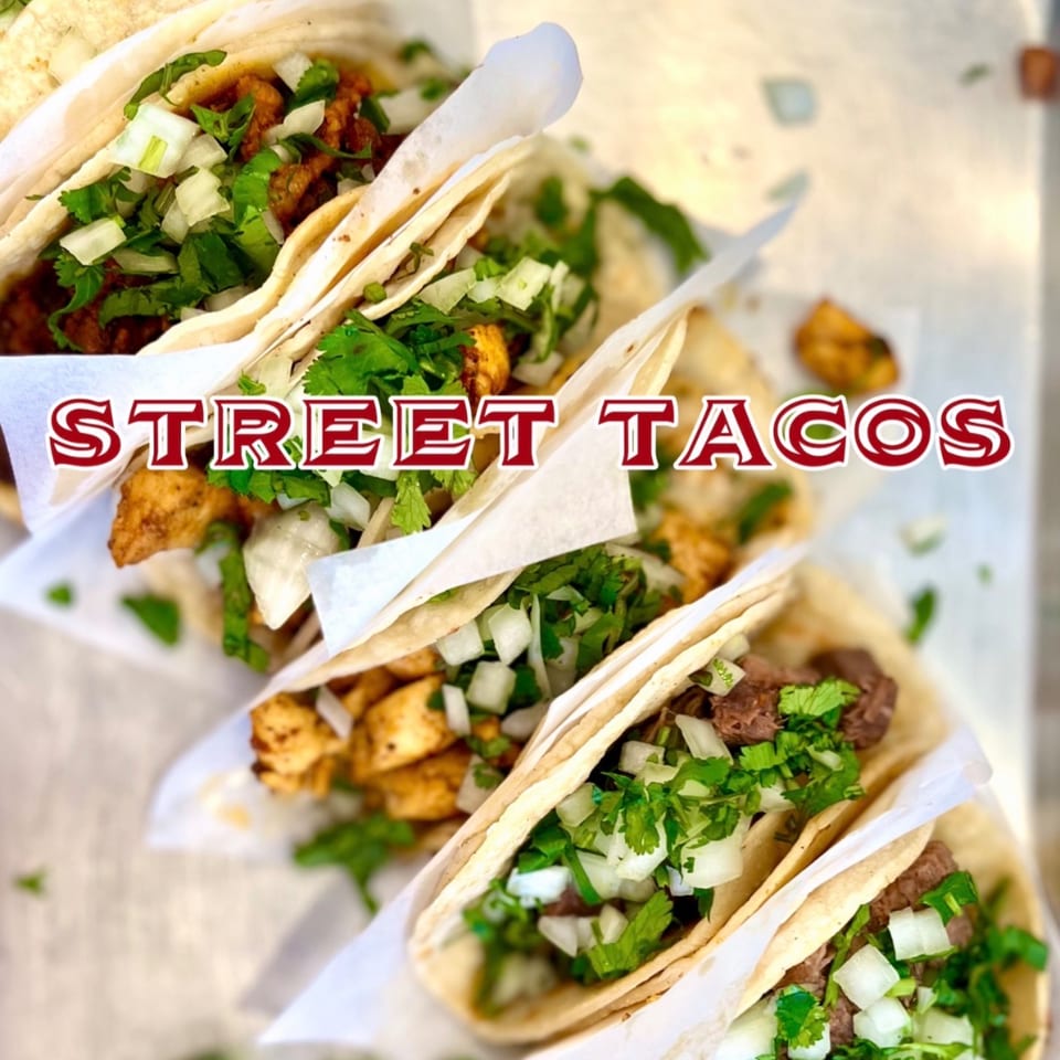 Four delicious street tacos from Taco el Diablo, filled with meat, cilantro, and diced onions.